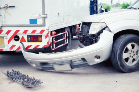 White Car Collided With A Truck