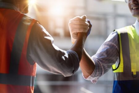 Two Workers Performing Handshake