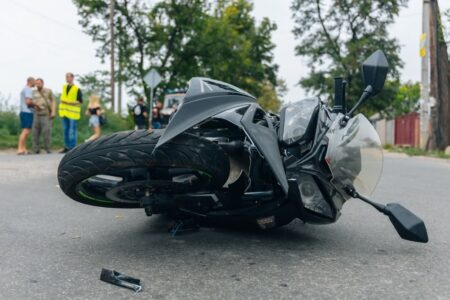 Black Motorcycle Laying On The Road